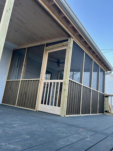 Wooden screened porch with gray decking and screen door